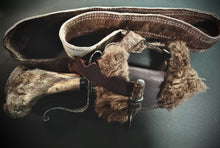 Load image into Gallery viewer, Decorative knife with leather sheath and fur accents on a dark background