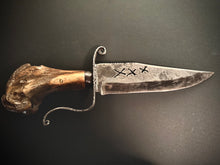 Load image into Gallery viewer, Decorative knife with leather sheath and fur accents on a dark background