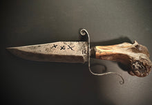 Load image into Gallery viewer, Decorative knife with leather sheath and fur accents on a dark background